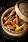 Chanteney carrots in bamboo steamer, close-up. — Stock Photo