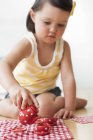 Toddler playing with teapot and cups — Stock Photo