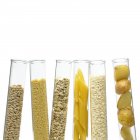 Grains and carbohydrates in test tubes. — Stock Photo