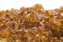 Close-up of citrine crystals on white background. — Stock Photo