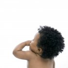 Rear view of baby girl with black curly hair. — Stock Photo