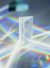White light passing through triangular prism and producing spectrum. — Stock Photo