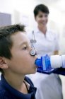 Preteen boy undergoing lung function test with female nurse. — Stock Photo
