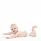 Baby boy lying on front and looking in camera. — Stock Photo