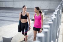 Women in sports clothing walking outdoors — Stock Photo