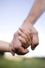 Father and son holding hands, close-up. — Stock Photo