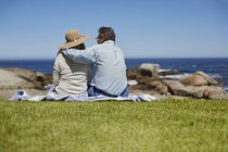 Senior couple resting on picnic, rear view. — Stock Photo