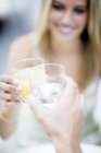 Friends toasting drinks in bar, close-up. — Stock Photo