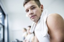Portrait of man with towel in gym. — Stock Photo
