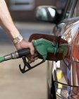Male hand refuelling car with unleaded petrol. — Stock Photo