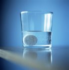Soluble painkiller in glass of water. — Stock Photo