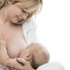 Close-up of mother breastfeeding infant baby. — Stock Photo