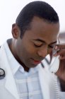Male African American doctor making telephone call. — Stock Photo