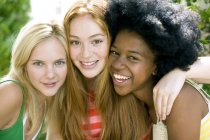 Three cheerful teenage girls hanging out outdoors. — Stock Photo