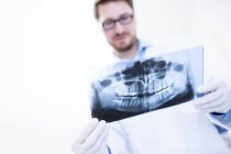 Dentist looking at x-ray image — Stock Photo