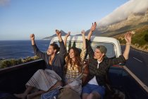 Friends riding in pick up truck with arms outstretched. — Stock Photo