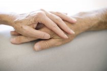 Close-up of senior couple holding hands. — Stock Photo