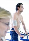 Mature doctor testing heart of male athlete on treadmill. — Stock Photo