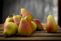 Guyot pears on wooden surface, still life. — Stock Photo