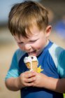 Toddler boy eating ice cream outdoors. — Stock Photo