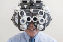 Man having eye test with special equipment. — Stock Photo