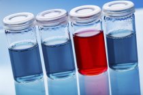 Vials with red and blue liquids. — Stock Photo