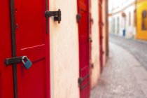 Red door and padlock, close-up. — Stock Photo