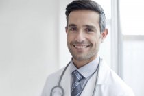 Male doctor smiling and looking in camera, portrait. — Stock Photo