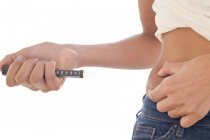 Woman making self-injection in tummy. — Stock Photo