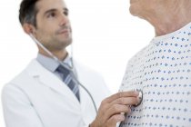 Male doctor examining male senior patient. — Stock Photo