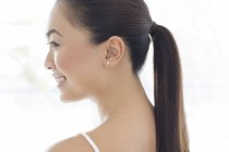 Young smiling woman with ponytail, profile. — Stock Photo