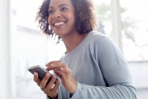 Happy woman using cell phone — Stock Photo