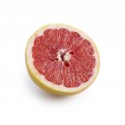 Half of pink grapefruit on white background. — Stock Photo