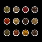 Dried spices in small bowls, overhead view. — Stock Photo