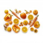 Fresh orange fruits and vegetables on white background. — Stock Photo