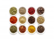 Dried spices in small bowls, overhead view. — Stock Photo