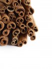 Cinnamon sticks on white background, full frame. — Stock Photo