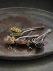 Sprouting beans in spoons on tray, studio shot. — Stock Photo
