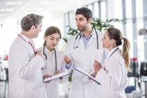 Medical colleagues standing with clip boards. — Stock Photo