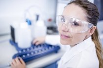 Female laboratory assistant using equipment. — Stock Photo
