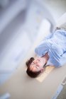 Female patient lying down on x-ray machine bed. — Stock Photo
