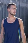 Young man in blue vest looking away, portrait. — Stock Photo