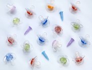 Test tubes and baby pacifiers on plain background. — Stock Photo