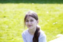 Усміхнена дівчина дев'ятнадцять позує в сонячному парку . — стокове фото