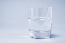 Glass of pure water on plain background. — Stock Photo