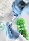 Scientist pipetting sample in microcentrifuge tube for chemical analysis. — Stock Photo