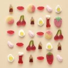 Shaped colored gummy candies arrangement on beige background. — Stock Photo