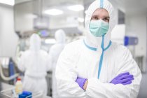 Технік лабораторії в захисний одяг в стерильних лабораторному середовищі. — стокове фото