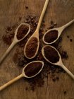 Wooden spoons with ground coffee on rustic background. — Stock Photo
