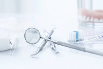 Dental clinic equipment and tools against white background. — Stock Photo